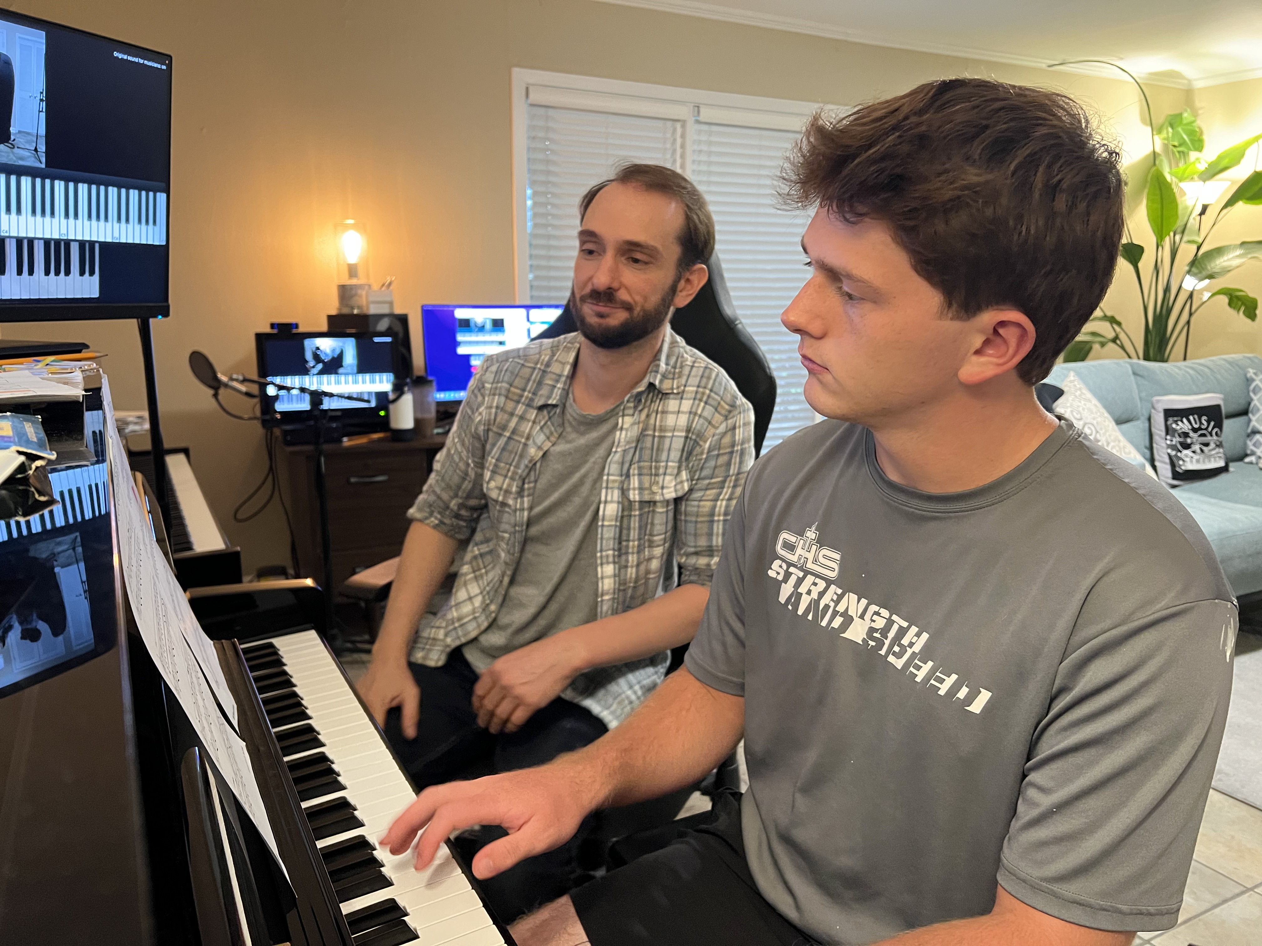 Jon teaching a student at the piano