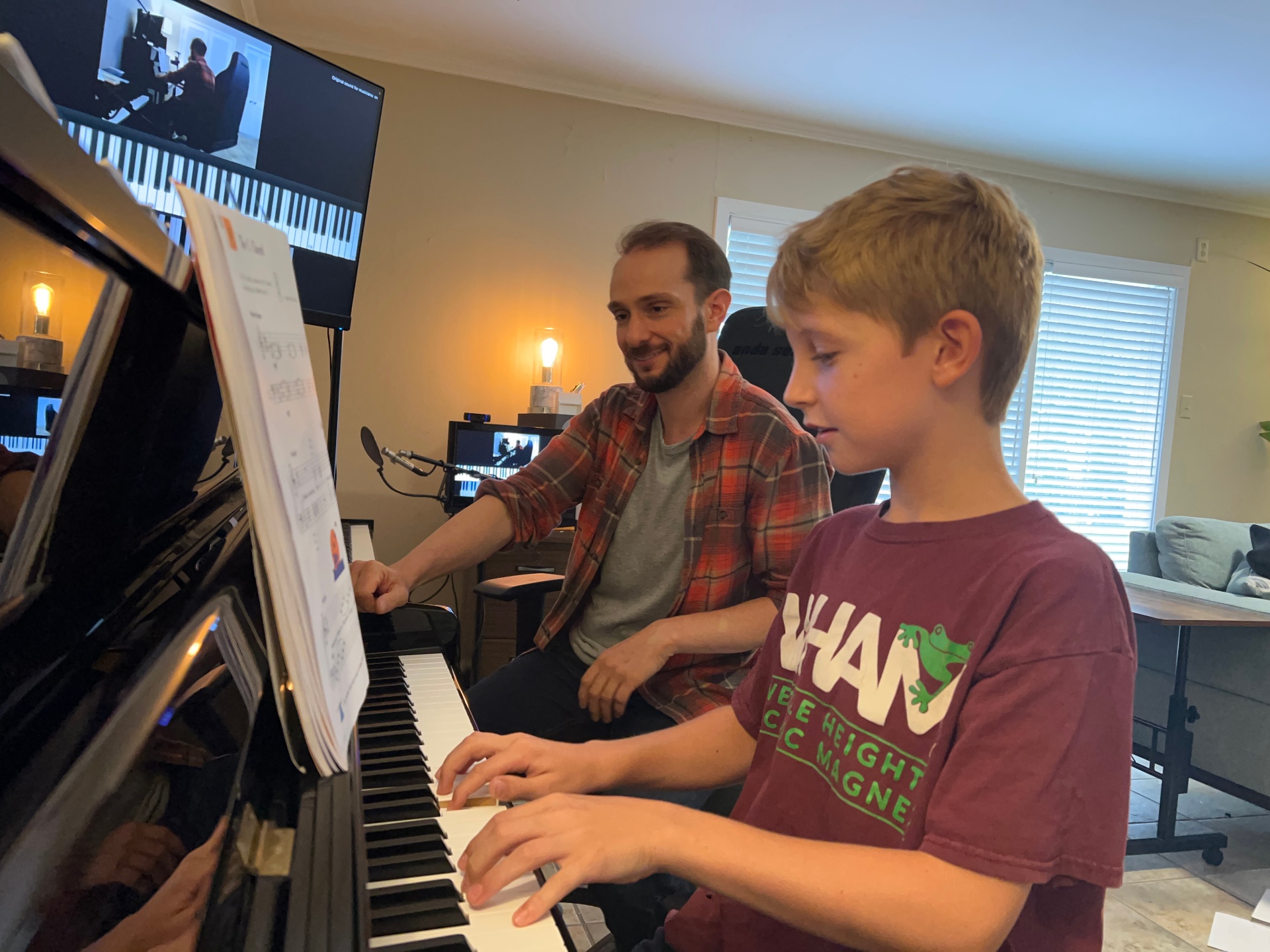 Student learning at the piano during a lesson