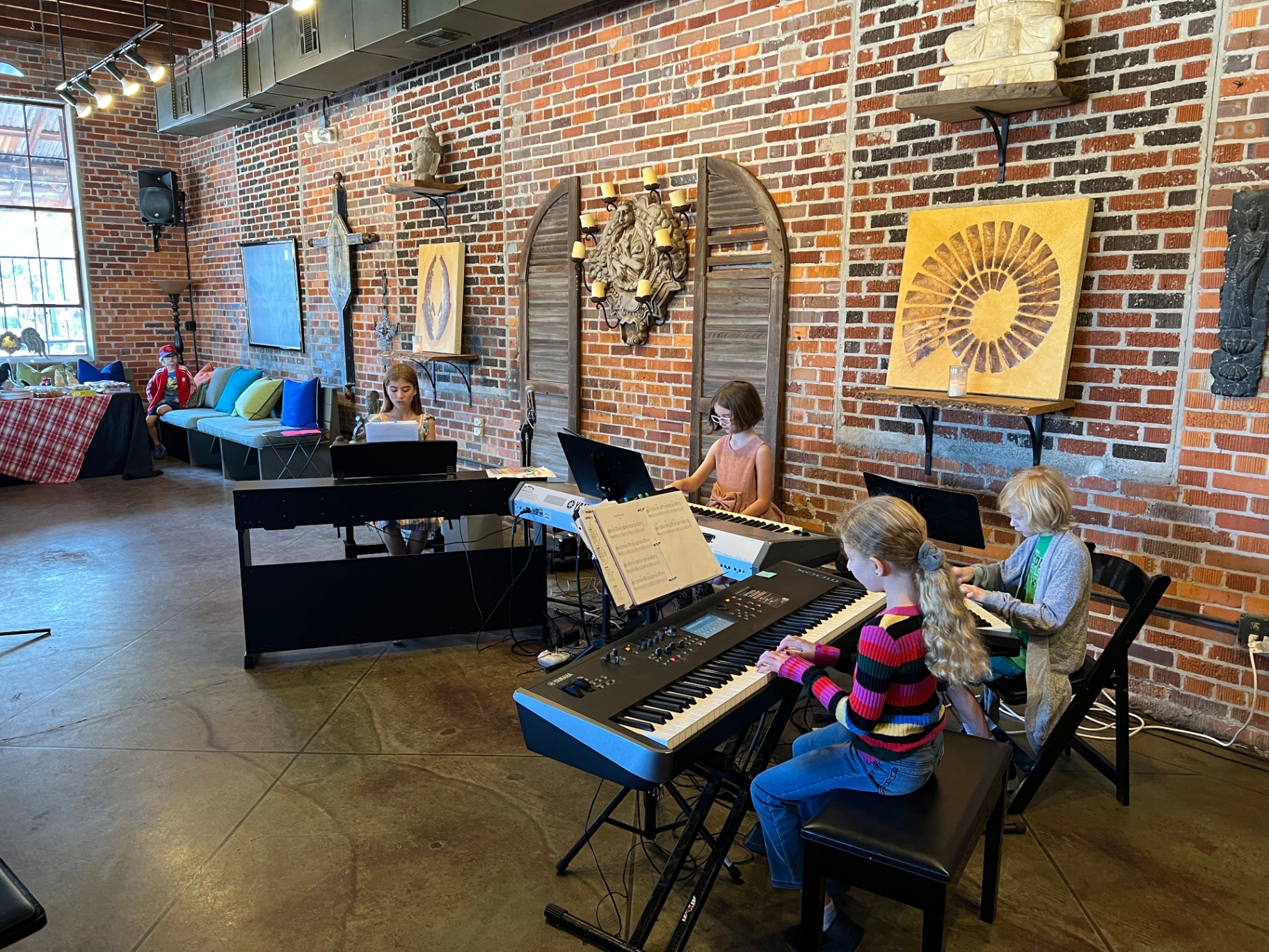 Keyboard ensemble students on multiple keyboards